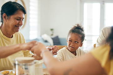 Image showing Family home, lunch and holding hands for praying together, religion or faith with comic girl child at table. Grandmother, kid peeping and prayer for food, celebration or party in house for blessing