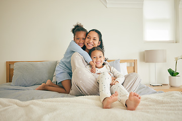 Image showing Mom, children and hug on bed, portrait and happy family home with love, care and bonding together. Young kids, mother and daughter with embrace, bedroom and relax in pyjamas with smile in apartment