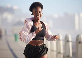 Image showing Portrait, running and black woman outdoor with music earphones, radio and podcast. Sports, fitness and happy African athlete training, workout and exercise for healthy body, wellness and cardio