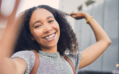 Image showing .Outdoor, excited and woman with a smile, selfie and curly with joy, social media and travelling. Portrait, female person and girl with happiness, city and profile picture with curly hair and post.