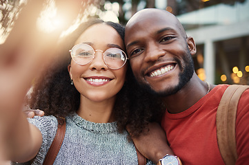 Image showing .Selfie, freedom and smile with an interracial couple in the city together for travel, tourism or adventure overseas. Portrait, love or fun with a man and woman taking a photograph in an urban town.