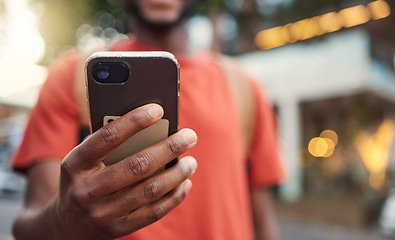 Image showing .Closeup, city and hand with a smartphone, typing and connection to check emails, chatting and message. Man, cellphone and mobile app with network, outdoor and social media with website information.