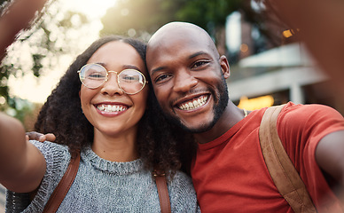 Image showing .Selfie, love and smile with an interracial couple in the city together for travel, tourism or adventure overseas. Portrait, freedom or fun with a man and woman taking a photograph in an urban town.