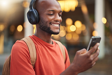 Image showing City, headphones and black man with smartphone, typing and connection with social media, audio and streaming music. Outdoor, radio and male person with a cellphone, mobile app and headset with sound