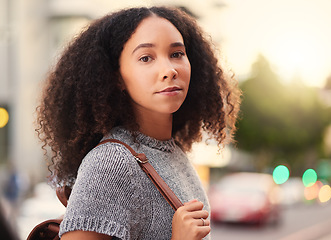Image showing .Young, serious and portrait of a woman in the city waiting for a cab, lift or public transport. Beautiful, confident and headshot of a female person from Mexico walking in an urban town street.