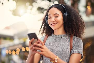 Image showing .City, headphones and woman with smartphone, typing and connection with happiness, social media and streaming music. Outdoor, female person and girl with a cellphone, contact and headset with audio.