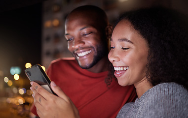 Image showing .Phone, social media and funny couple in the city at night for love, freedom or fun together. Face, meme or mobile with a black man and woman in an urban town to enjoy nightlife while bonding.