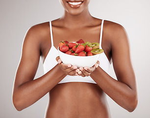 Image showing Woman, hands and diet with bowl of fruit for natural nutrition against a white studio background. Closeup of female person holding organic strawberry, kiwi or salad to lose weight or healthy wellness