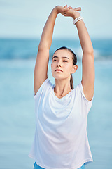 Image showing Woman, beach and stretching body in yoga for fitness, exercise or spiritual wellness in outdoor workout. Female person, yogi or runner in warm up on ocean coast for sports, zen or meditation outside