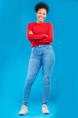 Image showing Fashion, smile and portrait of a woman with style and confident isolated in a studio blue background. Casual, outfit and full body of a happy young female person with stylish or trendy clothes