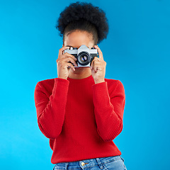 Image showing Photographer woman, retro camera and studio for photoshoot, memory or magazine by blue background. Young journalist girl, vintage tech and lens for paparazzi, newspaper or work at content creator job