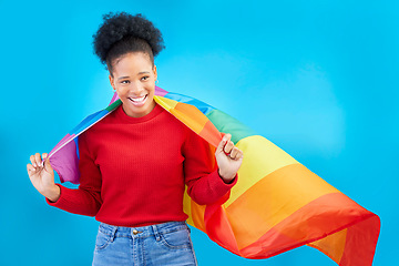 Image showing African woman, pride flag and smile in studio, thinking and excited for human rights, equality and inclusion. Girl, student and rainbow fabric for protest, freedom and lgbtq vision by blue background