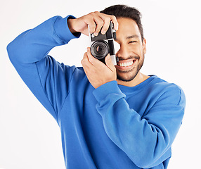 Image showing Camera, photographer and portrait of asian man in studio for photoshoot, creativity and paparazzi. Happy journalist, photography and shooting with vintage equipment for production on white background