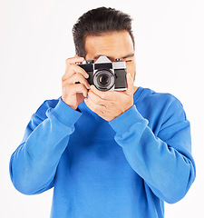 Image showing Retro camera, photography and man in studio for photoshoot, creative media and paparazzi. Male photographer, journalist and shooting with vintage equipment for production, lens and white background