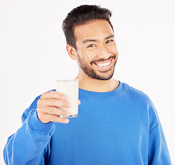 Image showing Portrait, man and smile with milk in studio, white background and backdrop for healthy benefits. Asian male model, glass and calcium of smoothie, vanilla milkshake or drinking diet of dairy nutrition