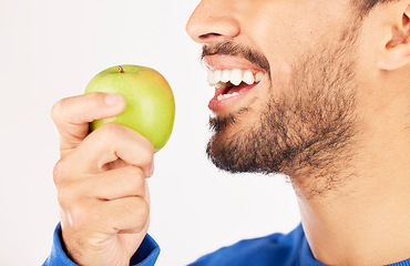 Image showing Closeup, man and hands with apple for diet, natural nutrition or vitamin against a white studio background. Mouth of male person eating healthy organic fruit or bite for wellness, detox or fiber