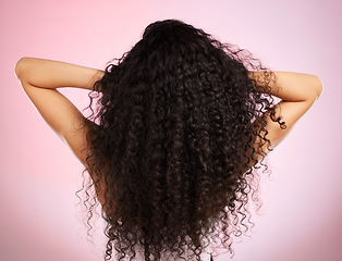 Image showing Hair, beauty and back of woman with hairstyle transformation and curly texture. Model, salon treatment and haircut shine in a studio with pink background and cosmetics with keratin and growth care