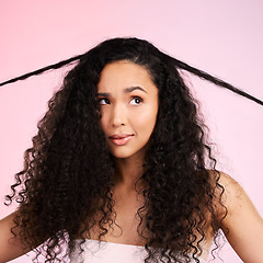 Image showing Hair damage, natural beauty and confused woman with growth treatment and hairstyle problem. Cosmetics, face and female person in studio worried from shampoo care and split ends with pink background