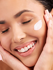 Image showing Beauty, cream and face of a happy woman with skin care, dermatology and natural glow. Closeup of a young female aesthetic model with a smile for moisturizer, cosmetics or sunscreen for wellness