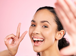 Image showing Selfie, peace sign and happy woman in studio with natural beauty, wellness and cosmetics. Portrait, female person and pink background with makeup and face with skincare and emoji hand gesture of girl
