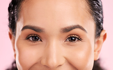 Image showing Beauty, portrait and closeup of woman eyes in a studio with natural, glamour and face routine. Cosmetic, facial and zoom of young female model from Mexico with cosmetology isolated by pink background