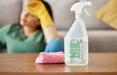 Image showing Cleaning, tired and woman with spray bottle in living room for , housework and maid service. Furniture, housekeeping and exhausted, fatigued and burnout female person with detergent products for dirt