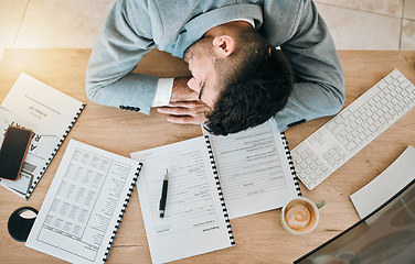 Image showing Top view, burnout and tired or man with sleeping at desk and exhausted at finance job. Employee, depressed and rest on table at work with fatigue or accountant with stress in office with documents.