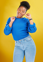 Image showing Happy, dance and young woman in studio for celebration, achievement or goal with confidence. Happiness, smile and African female model moving to music, song or playlist isolated by yellow background.