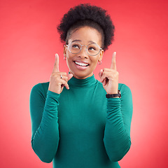 Image showing Looking up, black woman and hand pointing in studio for announcement, deal or promotion on red background. Finger, smile and African female show news, sale and competition info, giveaway or vote