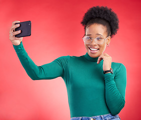 Image showing Selfie, smile and black woman in studio for profile picture, post or message on red background. Happy, photo and African female with memory on social media, dating app or online communication update