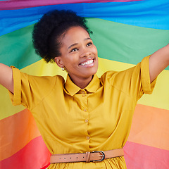 Image showing Gay, flag and happy black woman in studio for pride, rights and lgbtq lifestyle choice. Rainbow, freedom and face of lesbian African female smile, free and confident with queer sexuality or identity