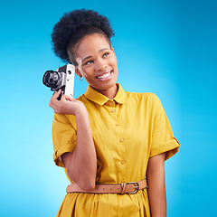 Image showing Photography, smile and black woman with camera isolated on blue background, creative artist job and talent. Art, face of happy photographer with hobby or career in studio on travel holiday photoshoot