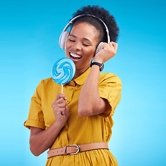 Image showing Music, singer and lollipop with black woman and headphones for streaming, audio and media. Radio, technology and freedom with female person on blue background for listening, sound and podcast