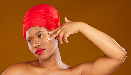 Image showing Woman, face touch and hair scarf with natural beauty, makeup and haircare in studio. Brown background, African female person and cosmetics of a model with head wrap for culture with skincare glow