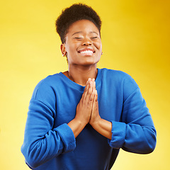 Image showing Thank you, hands and black woman praying in studio happy, relief and grateful on yellow background. Blessing, gratitude and African female smile for good news, outcome or results, solution or answer