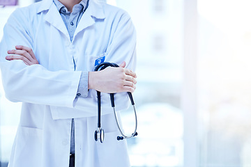 Image showing Stethoscope in hand, health and doctor with arms crossed, medical person and cardiology and surgeon in hospital. Mockup space, cardiovascular healthcare and professional expert in medicine at clinic