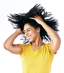 Image showing Hair, dancing and crazy woman with afro hairstyle, smile and fashion isolated in a studio white background. Energy, casual and young person with stylish or trendy clothes happy, celebrate and freedom