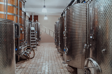 Image showing Modern wine distillery and brewery with brew kettles pipes and stainless steel tanks