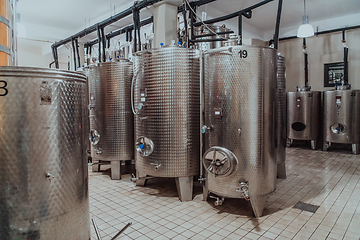 Image showing Modern wine distillery and brewery with brew kettles pipes and stainless steel tanks