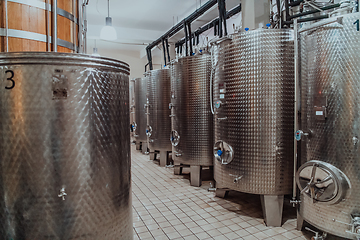 Image showing Modern wine distillery and brewery with brew kettles pipes and stainless steel tanks