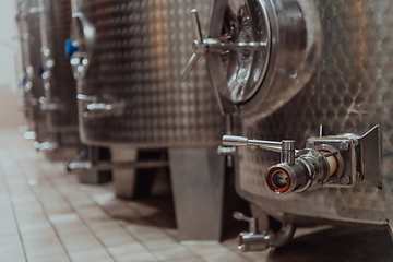 Image showing Modern wine distillery and brewery with brew kettles pipes and stainless steel tanks