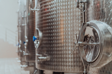 Image showing Modern wine distillery and brewery with brew kettles pipes and stainless steel tanks