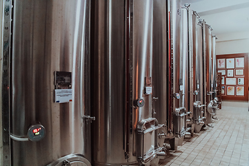 Image showing Modern wine distillery and brewery with brew kettles pipes and stainless steel tanks