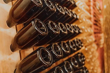 Image showing Wine or cognac barrels in the cellar of the winery, Wooden wine barrels in perspective. Wine vaults.Vintage oak barrels of craft beer or brandy.