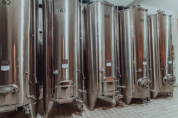 Image showing Modern wine distillery and brewery with brew kettles pipes and stainless steel tanks