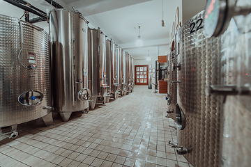 Image showing Modern wine distillery and brewery with brew kettles pipes and stainless steel tanks