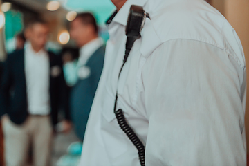 Image showing A close-up photo of a guard holding a communication device