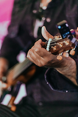 Image showing Practicing in playing guitar. Handsome young men playing guitar