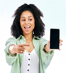 Image showing Screen, mockup or woman excited by phone on white background on social media or product placement. Pointing, smile or happy person showing mobile app promo, website or tech mock up space in studio