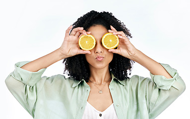 Image showing Vitamin c, lemon and eye of woman with a pout for organic wellness or fashion isolated in a studio white background. Diet, fruit and happy or excited young person with crazy citrus energy and detox
